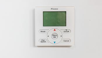 an electric thermostat on a white wall with a green screen at The Commonwealth Building, Pittsburgh, Pennsylvania
